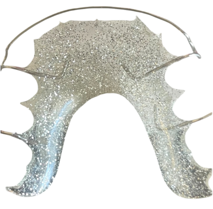Silver glittery retainer on a white background